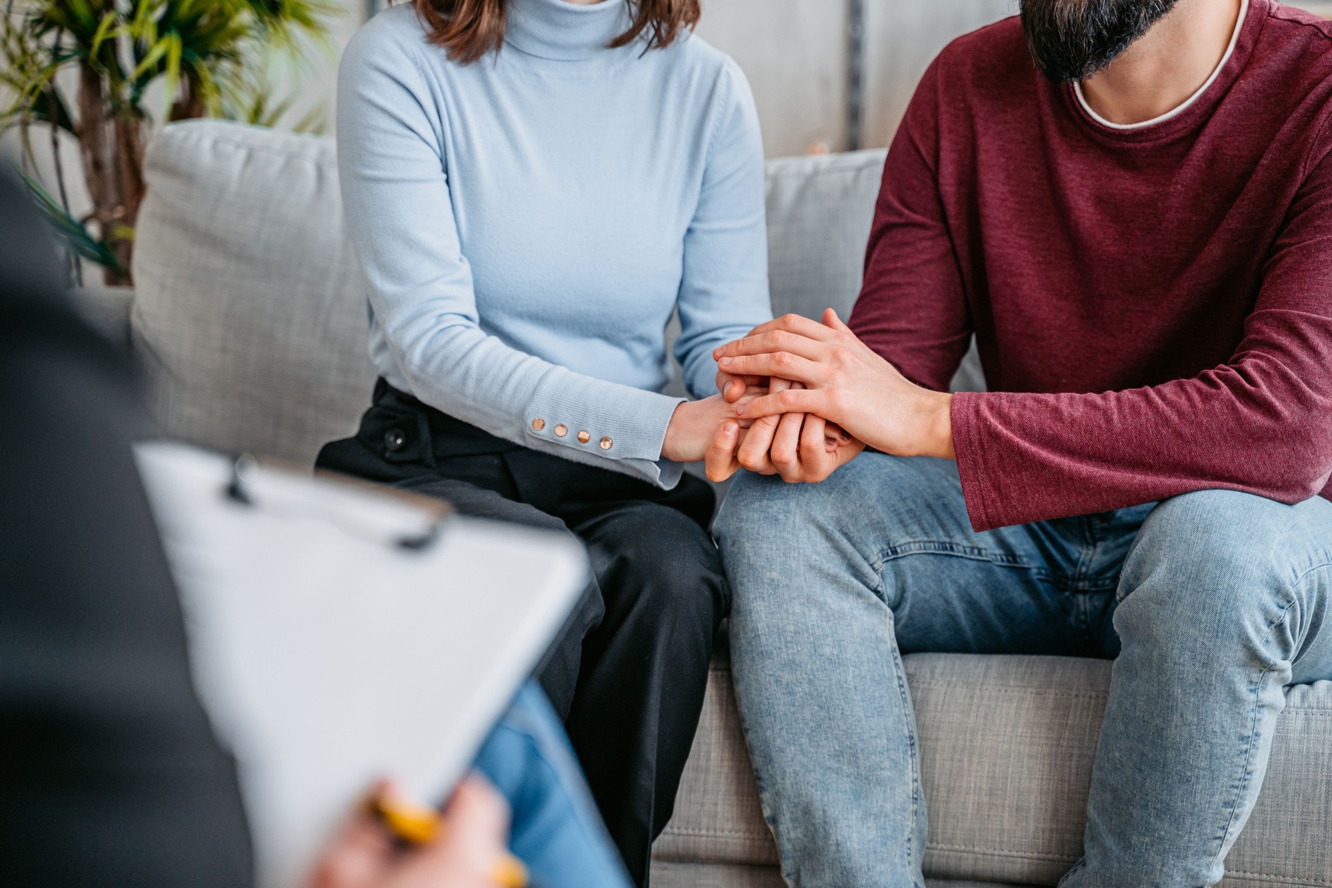 Young Couple Holding Hands While Having A Marriage Counseling Session